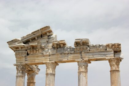 a picture depicting a crumbling stone structure in front of a cloudy sky. image featured in Bookish Brews post "Decolonizing Story Structure and Literary Form with Lilly Lu"
